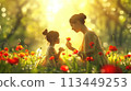 Mother and Daughter Sitting in a Field of Flowers 113449253