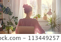 Young Female Entrepreneur Working on Laptop in Sunny Home Office 113449257