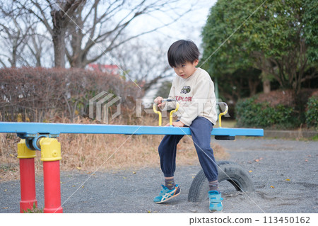 Boy playing with seesaw 113450162
