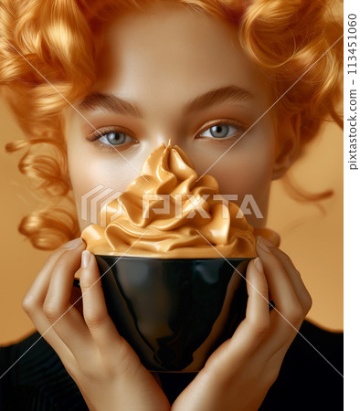 Close up of young blonde woman holding a cup of whipped coffee on a beige background 113451060
