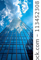 A view of a tall building with lots of windows and clouds, AI 113452308