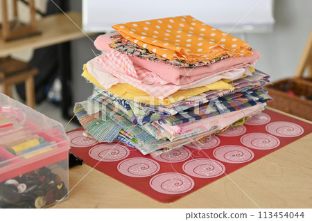 Colorful Cotton Fabric Scraps Pile for Creative Design Projects on White Background Colorful Cotton Fabric Scraps Pile for Creative Design Projects on White Background 113454044