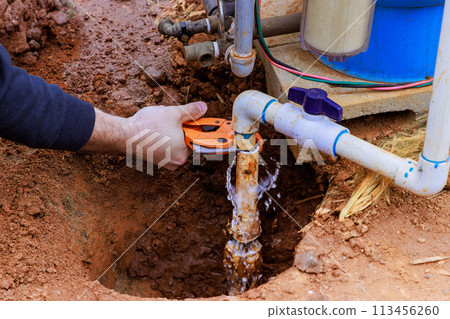 As part of repair work, technician plumber uses specialized scissors to cut plastic PVC pipe As part of repair work, technician plumber uses specialized scissors to cut plastic PVC pipe 113456260