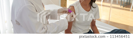 Web banner with doctor applying bandage on arm of patient after vaccination 113456451