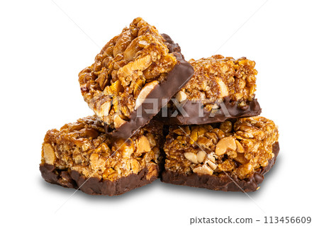 Pile of crispy homemade peanuts, almond and chocolate mini protein bars. 113456609