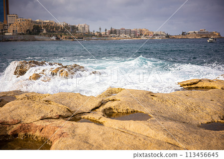Light waves of the ocean on a rocky shore Coast of the island of Malta in winter Light waves of the ocean on a rocky shore Coast of the island of Malta in winter 113456645
