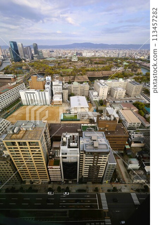 Bird's-eye view of Osaka Castle from the sky Cherry blossom season Ikoma mountain range Cherry blossoms in full bloom against the blue spring sky Bird's-eye view of Osaka Castle from the sky Cherry blossom season Ikoma mountain range Cherry blossoms in full bloom against the blue spring sky 113457282