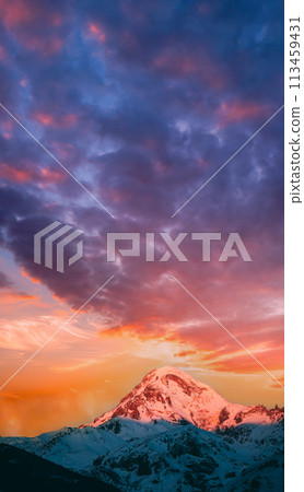 Georgia. Mount Kazbek Covered Snow In Winter Sunrise. Morning Dawn Colored Top Of Mountain In Pink-orange Colors. Awesome Winter Georgian Nature Landscape. 113459431