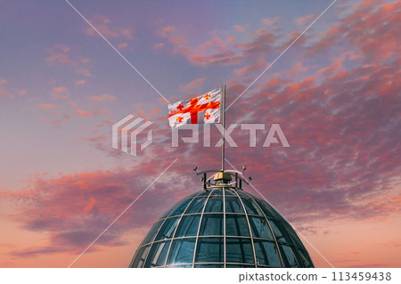 Tbilisi, Georgia. Flag Of Georgia, Five Cross Flag, Waving On Flagpole On Presidential Administration Palace, Avlabari Residence Roof. Close Up Tbilisi, Georgia. Flag Of Georgia, Five Cross Flag, Waving On Flagpole On Presidential Administration Palace, Avlabari Residence Roof. Close Up 113459438