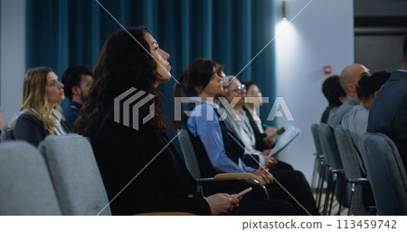 Multiethnic press workers sit in the conference room during press campaign Multiethnic press workers sit in the conference room during press campaign 113459742