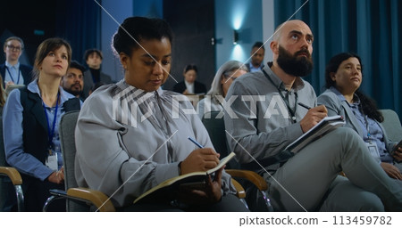 Journalists listen and write answers from politician during press campaign 113459782