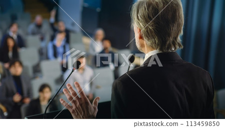 Back view of politician or activist pronouncing speech during press campaign 113459850