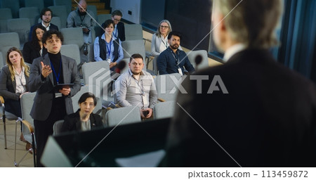 Back view of politician or activist pronouncing speech during press campaign Back view of politician or activist pronouncing speech during press campaign 113459872
