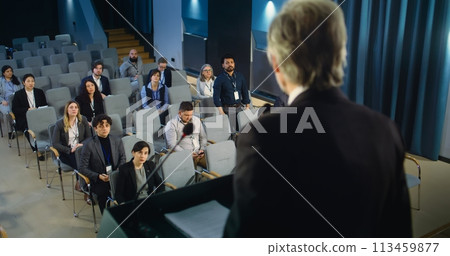 Back view of politician or activist pronouncing speech during press campaign Back view of politician or activist pronouncing speech during press campaign 113459877