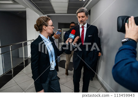 Mature organization representative answers press questions 113459943