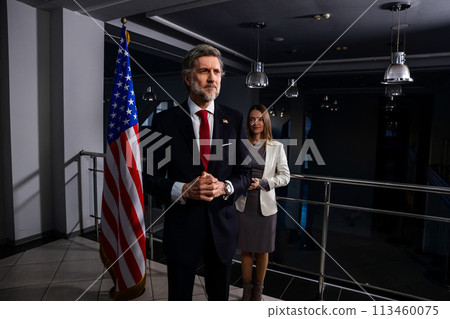 President of the USA waves his hand and poses for media cameras President of the USA waves his hand and poses for media cameras 113460075