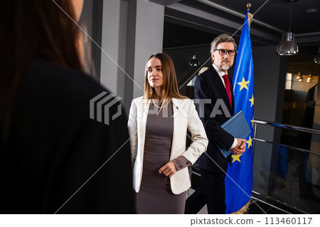 Female EU politician poses for the cameras and greets journalists Female EU politician poses for the cameras and greets journalists 113460117