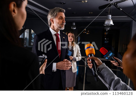 American politician talks with journalists, gives interview for media and television news 113460128