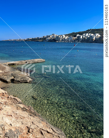 Coast and promenade of the town of Bugibba in Malta on a clear sunny day 113460163