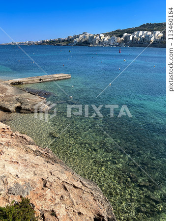 Coast and promenade of the town of Bugibba in Malta on a clear sunny day Coast and promenade of the town of Bugibba in Malta on a clear sunny day 113460164
