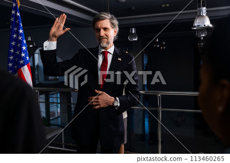 President of the USA waves his hand and poses for media cameras President of the USA waves his hand and poses for media cameras 113460265