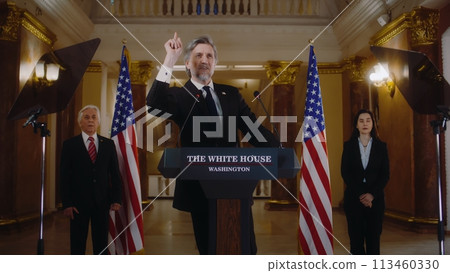 US President or congressman smiles and gestures after political speech 113460330