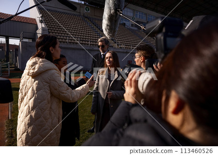 Two organization representative give interview outside 113460526