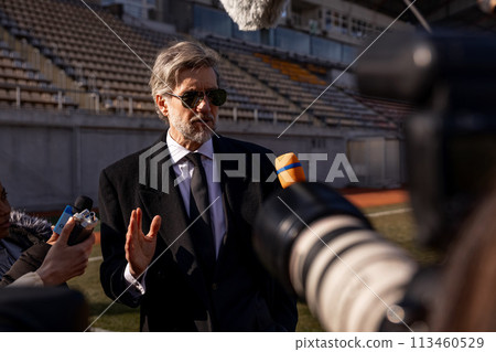 Interview of football team director at press conference for TV 113460529