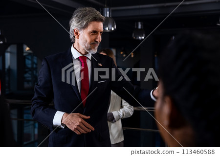 President of the USA waves his hand and poses for media cameras President of the USA waves his hand and poses for media cameras 113460588