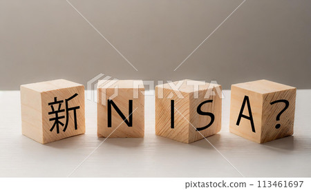 Wooden cube with "New NISA?" written on it 113461697