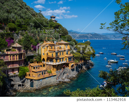 coast of the Mediterranean Sea in Italy, Portofino against the backdrop of a mountain immersed in greenery, a beautiful beach with vacationers coast of the Mediterranean Sea in Italy, Portofino against the backdrop of a mountain immersed in greenery, a beautiful beach with vacationers 113462916