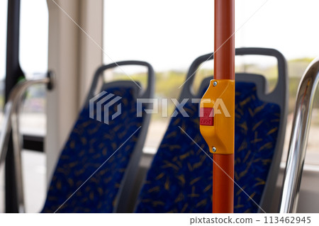 Handrail in city transport with button to stop, stop button in modern public transport with braille text for disabled people 113462945