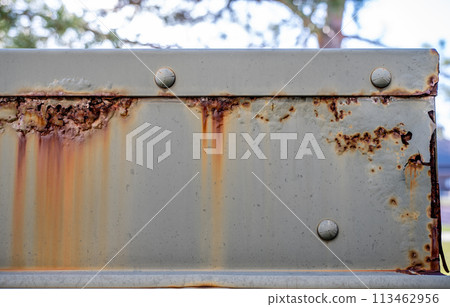 Rusted and peeling paint on an electrical transformer exposed to the elements. Rusted and peeling paint on an electrical transformer exposed to the elements. 113462956