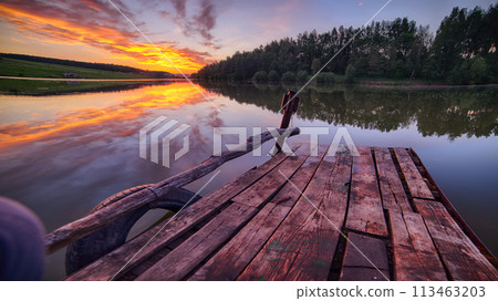 Amazing Wooden dock, pier, on a lake in the evening. 113463203