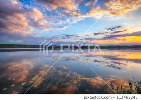 Amazing Dramatic sunset over the lake Amazing Dramatic sunset over the lake 113463243