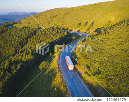Drone follows truck with cargo on mountain road 113465379