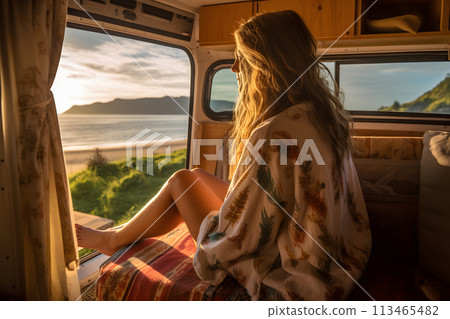 A woman in the camper van enjoying the view out the window on a bright morning A woman in the camper van enjoying the view out the window on a bright morning 113465482