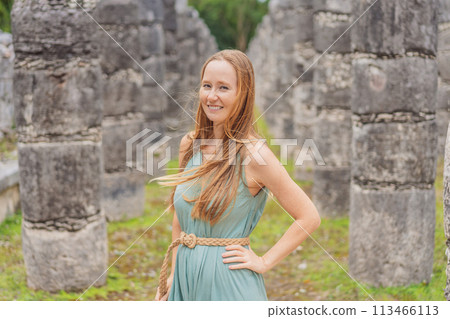 Beautiful tourist woman observing the old pyramid and temple of the castle of the Mayan architecture known as Chichen Itza these are the ruins of this ancient pre-columbian civilization and part of 113466113