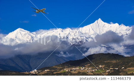 A plane flying over the steep and sacred peaks of Meili Snow Mountain 113466379