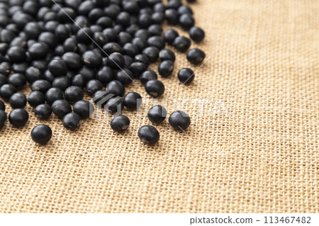 Black soybeans on a burlap sack 113467482