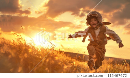 Young Boy Running Through Field at Sunset 113467672