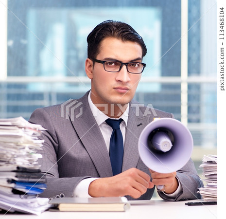 Angry businessman with loudspeaker in the office 113468104