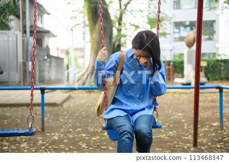 A woman killing time in the park A woman killing time in the park 113468347