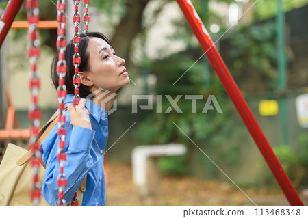A woman killing time in the park A woman killing time in the park 113468348