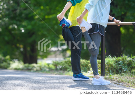 Woman doing warm-up exercise stretching Woman doing warm-up exercise stretching 113468446