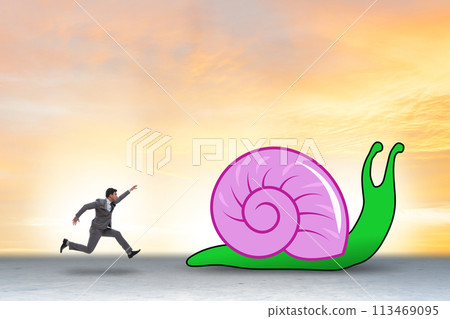 Businessman with snail in slow business concept Businessman with snail in slow business concept 113469095