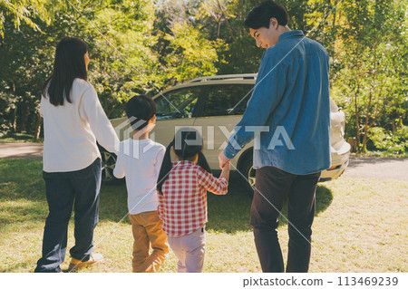A family gets into a car returning from playing in the park. A family gets into a car returning from playing in the park. 113469239