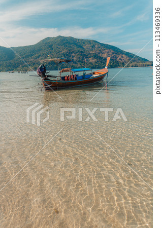 Wooden boat on the beach on the island Wooden boat on the beach on the island 113469336
