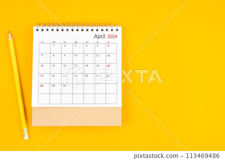 April 2024 desk calendar and wooden pencil on yellow color background. April 2024 desk calendar and wooden pencil on yellow color background. 113469486