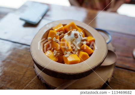 Mango yogurt on the table in a dessert shop Mango yogurt on the table in a dessert shop 113469682